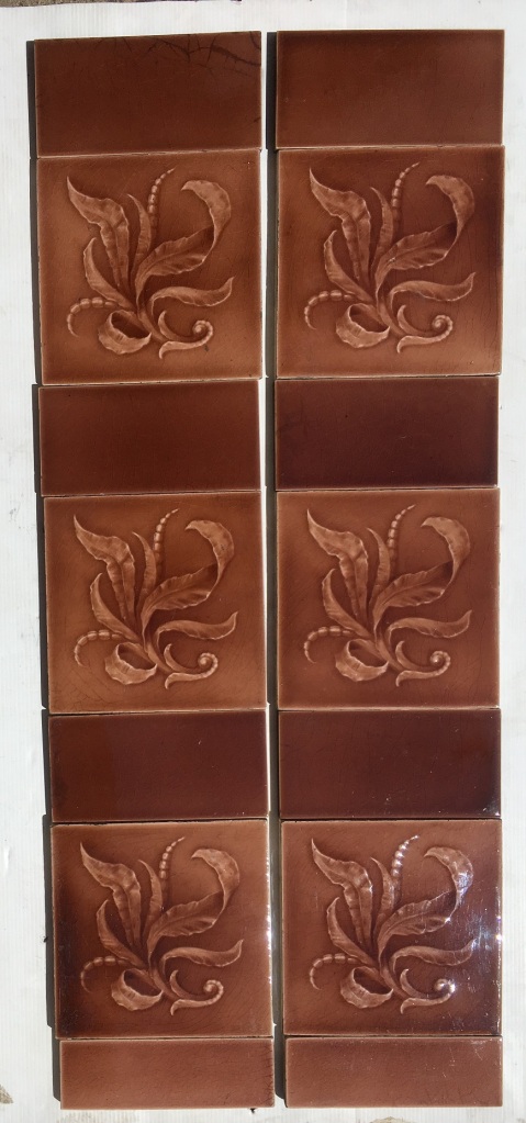 Original Sherwin and Cotton fireplace tiles, c1890 - 1911 warm pink / brown glaze on moulded tile with foliage. $300 for the two panel set SET 142