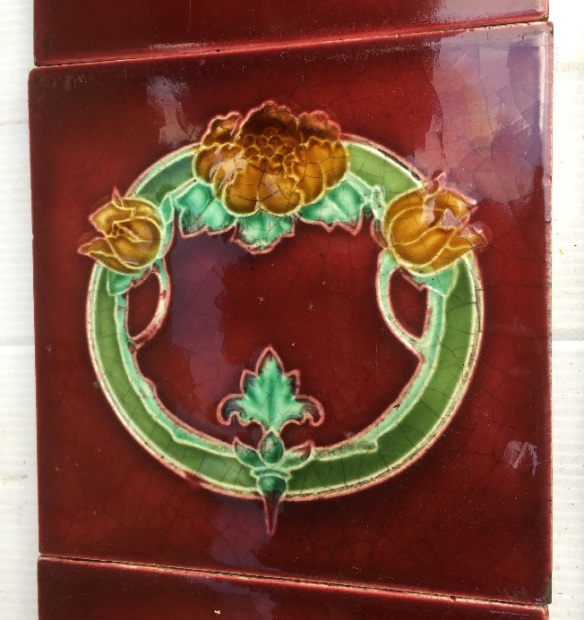 Detail of original T and R Boote, England, c1905 fireplace tile set, 6 x 6 inch circular floral design and 3 x 6 inch decorative tiles, rich burgundy glaze with deep yellow flowers, green foliage. Two panel fireplace set, $350 OTB 80 vintagesalvaged, recycled, demolition, reproduction, restoration, renovation,collectable, secondhand, used , original, old, reclaimed, heritage, antique, victorian, art nouveau edwardian, georgian, art deco